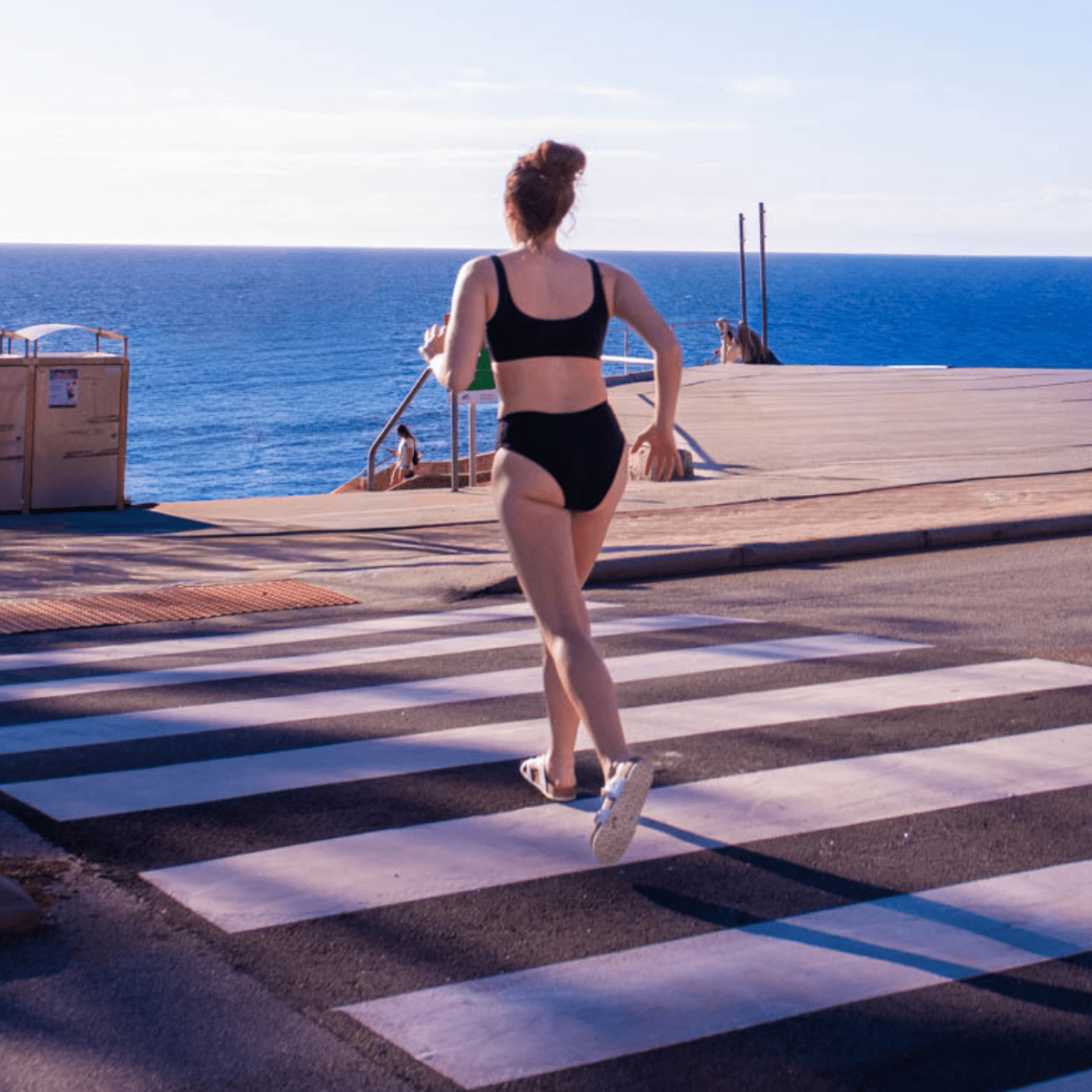 Teen girl wearing high leg period-proof bikini bottoms beach photo