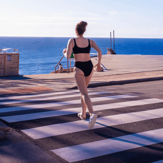 Teen girl wearing high leg period-proof bikini bottoms beach photo