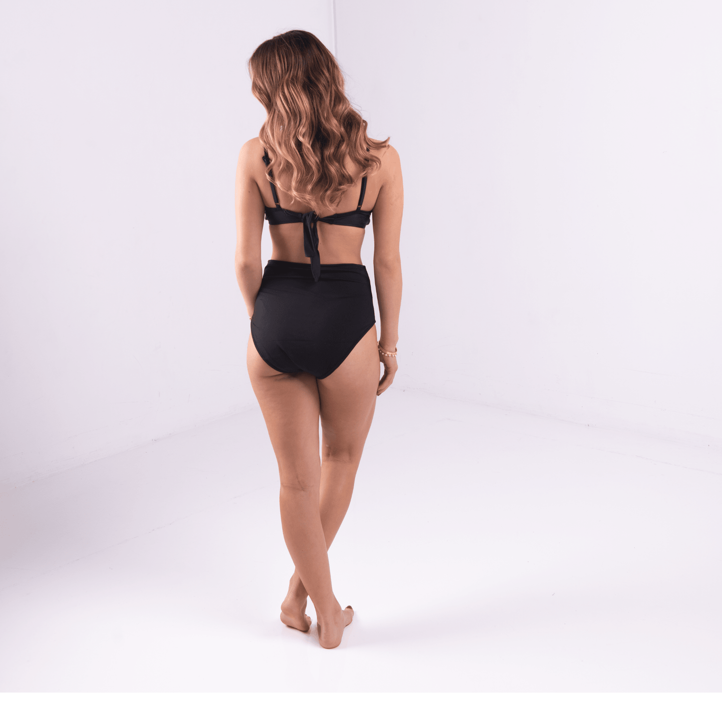 Teen girl in high waist period-proof bikini bottoms by the ocean