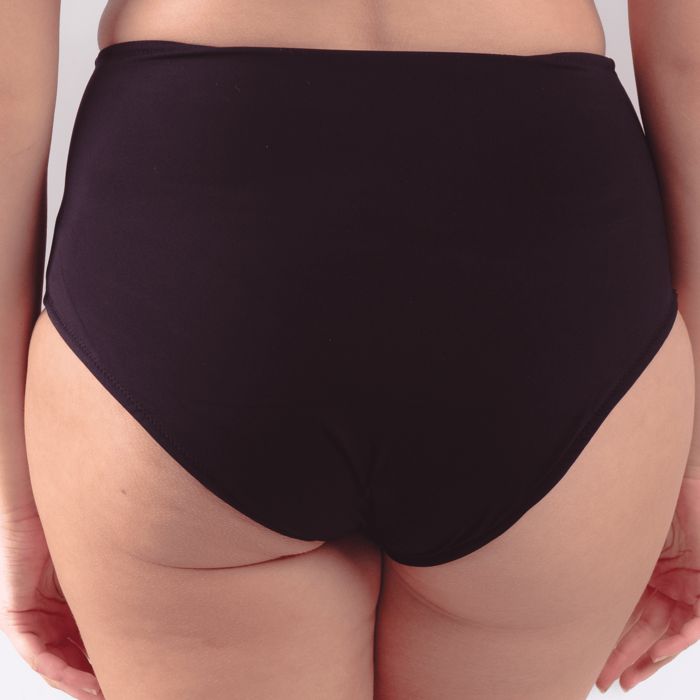Teen wearing ultra high waist period-proof swimwear at the beach