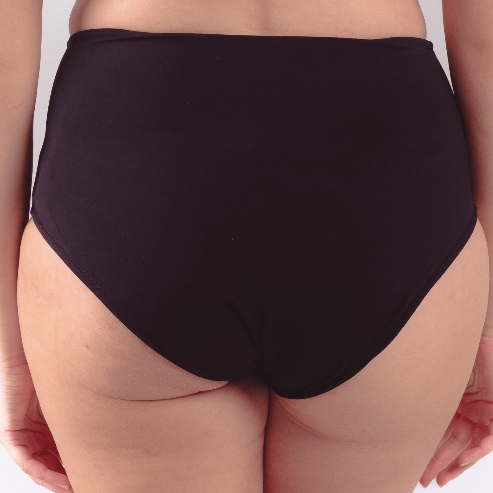 Teen wearing ultra high waist period-proof swimwear at the beach